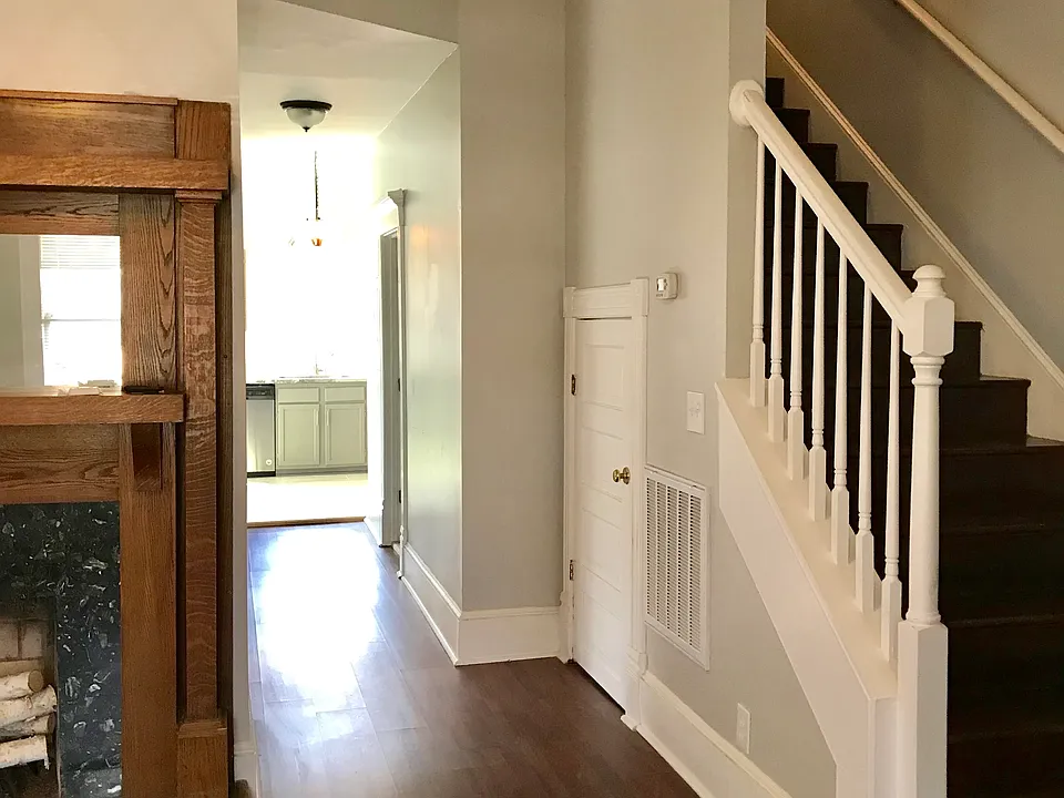 Living room with hallway to kitchen and upstairs