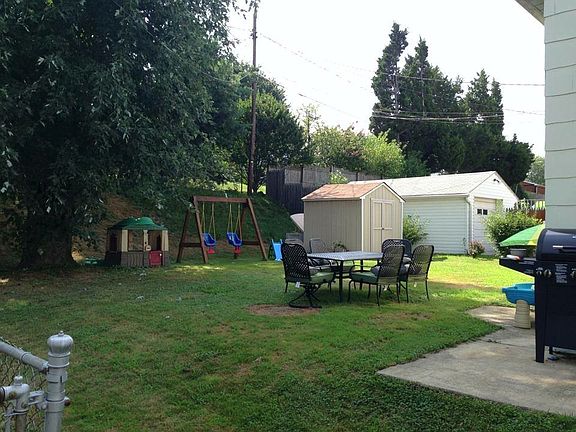 Spacious Back Yard: Double Swing Set, Storage Unit w/ Lawnmo