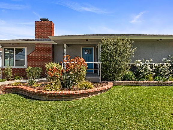 Front exterior- view of front yard, entry and porch