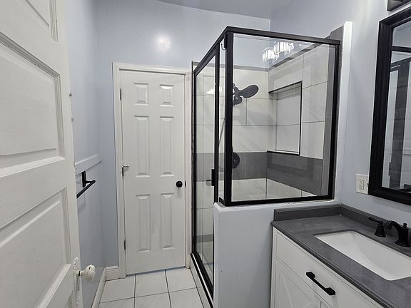 Custom shower bathroom with private toilet area