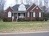 All Brick with rocking Chair Porch on .42 acre lot