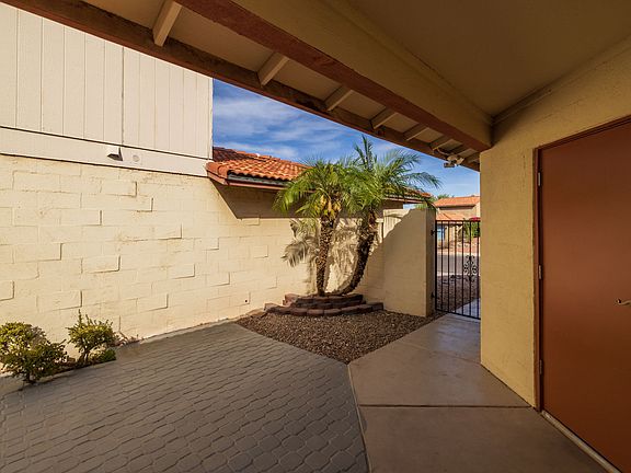 Front door tucked behind privacy gate.