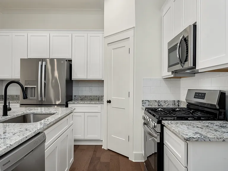 Gourmet kitchen includes:
Gas stove, GE Cafe Refrigerator, extra-large island, farmhouse sink, coffee/tea bar with prep sink. granite countertops and white shaker cabinets.