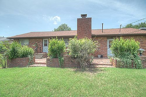 Large brick patio with built-in flower boxes.