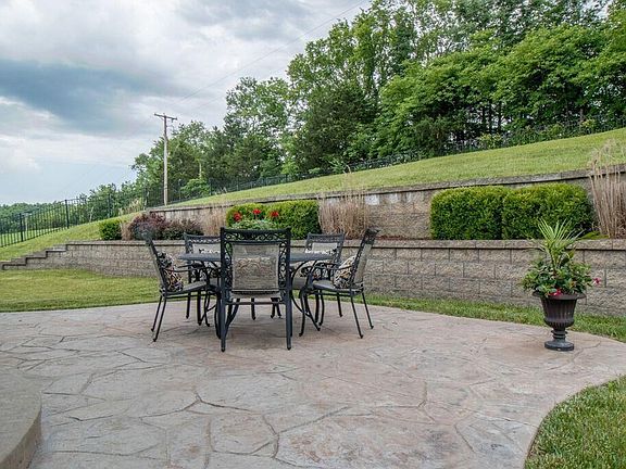 Patio with beautiful rounded stairs and stamped concrete!