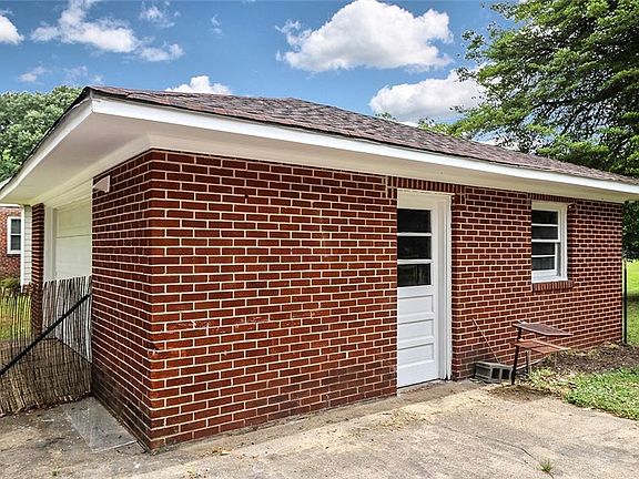 Oversized detached garage has lots of space for a workshop.