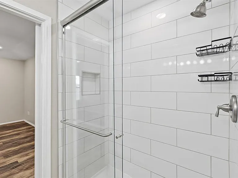 Full bath featuring a shower stall, dark wood-style flooring, and recessed lighting