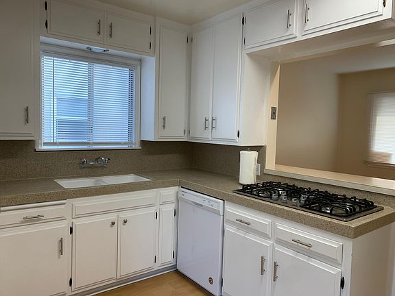 Spacious kitchen with numerous cabinets and storage space with bar top