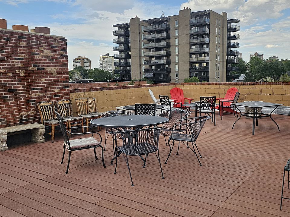 Rooftop with tables/chairs/ grill to have guests, enjoy food with panoramic city views