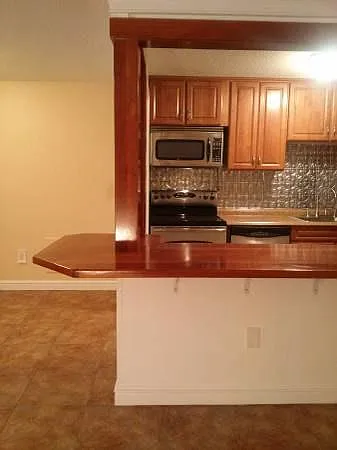 Remodeled kitchen with custom cherry breakfast bar