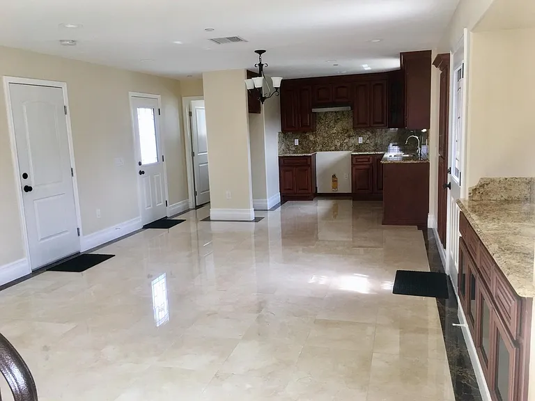 OPEN CONCEPT LIVING AREA. HALF BATH IN FAR LEFT SIDE. FRONT DOOR ON RIGHT SIDE, FAR LEFT DOOR TO OUTSIDE AND DRIVEWAY, OTHER DOOR TO GARAGE AND LAUNDRY AREA.