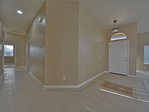 Entry and hallway split with high ceiling.