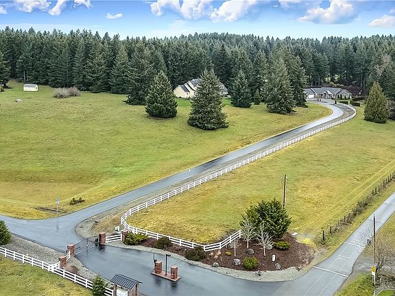 Drone view of property: Gated entry to small development, all of that pasture behind the white fence leading to the house is yours! Many possibilities. 