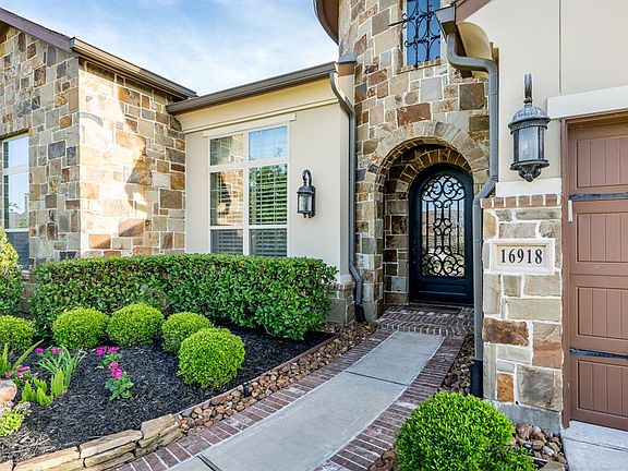 Brick-lined sidewalk and entry leads your guests to the exquisite double leaded glass front door.