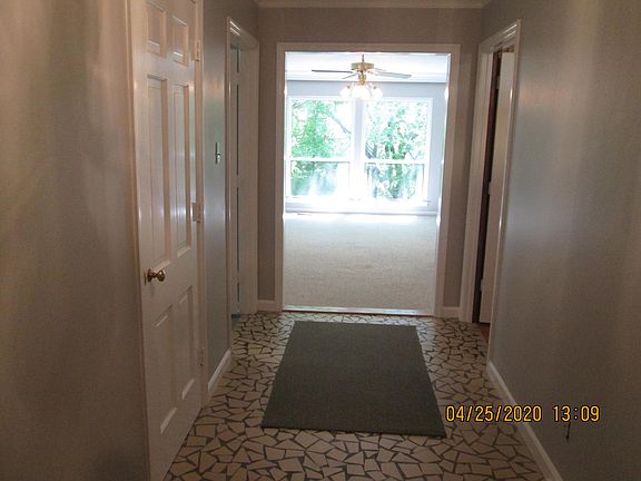 Entry view into living room. Features coat closet on the left.