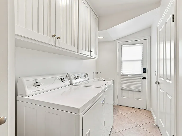 Laundry Room with storage and side yard access