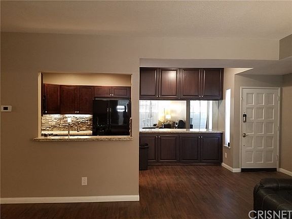 Kitchen and dining areas open into living room.