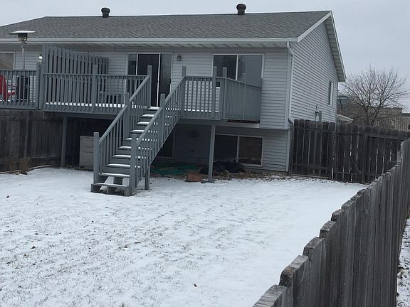 Fenced backyard with large deck