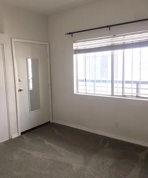 This bedroom has an exterior door, which is ideal for a home office.