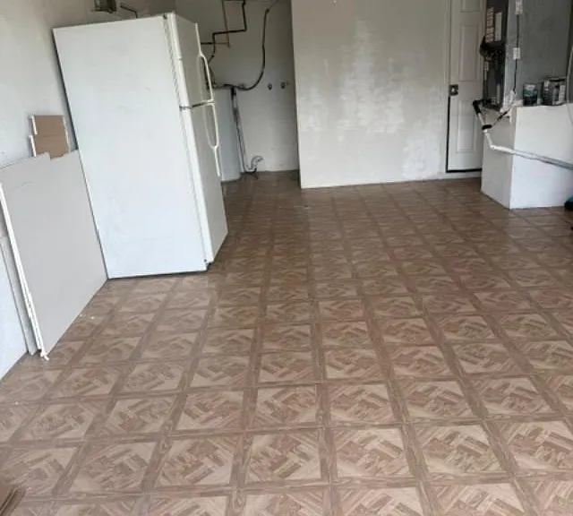 garage with 2nd refrigerator and washer/dryer hook up
