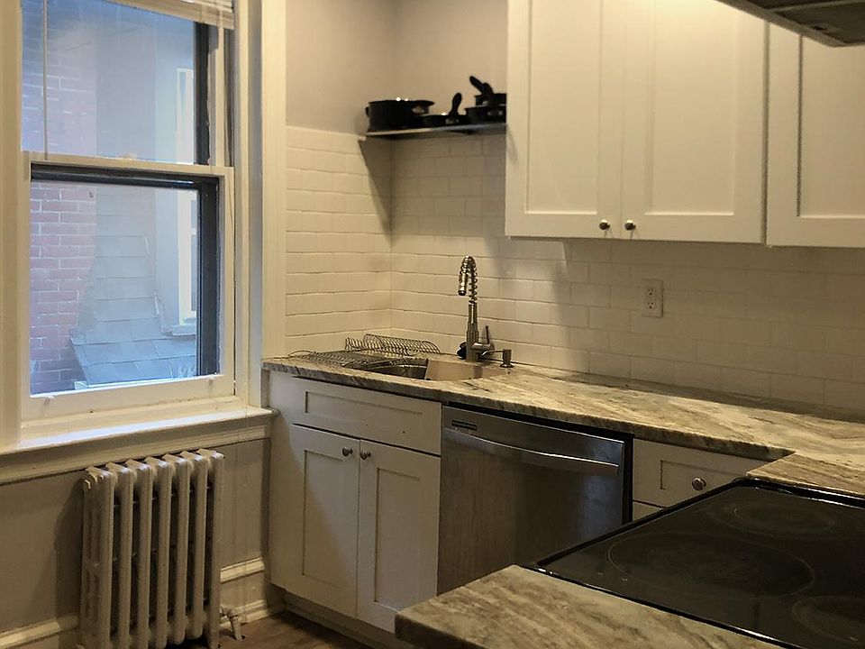 Renovated kitchen with granite countertops.
