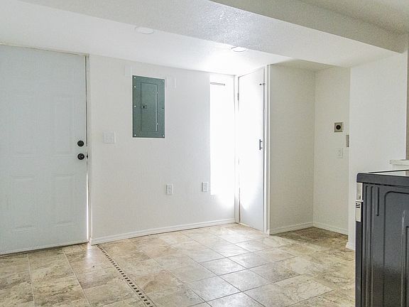 Kitchen, space for stackable laundry and entry to unit