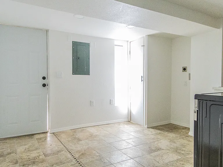Kitchen, space for stackable laundry and entry to unit
