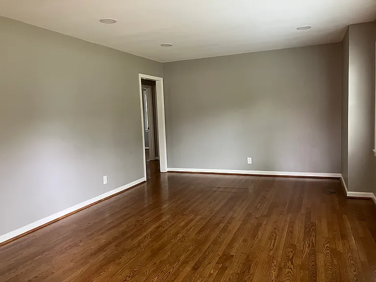 Living room showing door leading to two bedrooms