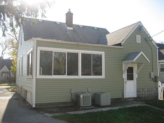 Back view of the house showing both AC units and covered rear door