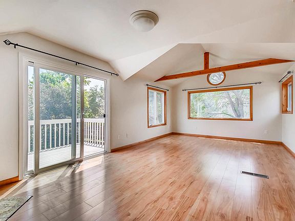 Master bedroom with private deck overlooking Parkside Park.