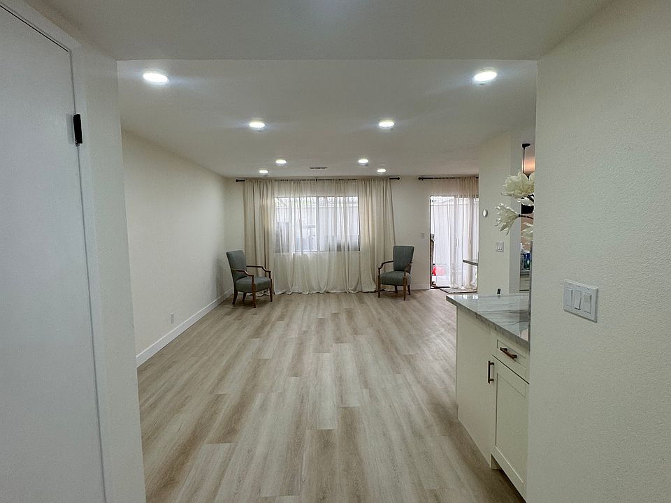 Living spaces and kitchen to rear side of the condo