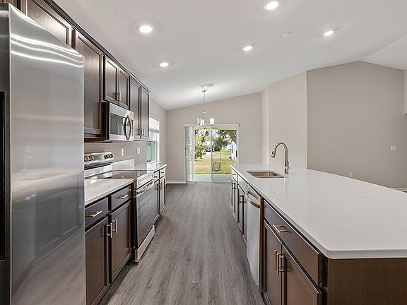 This beautiful, open-layout home includes luxury vinyl plank flooring, quartz countertops, and 36-in