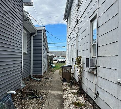 view from the front side yard into the backyard (entry door is on the right)