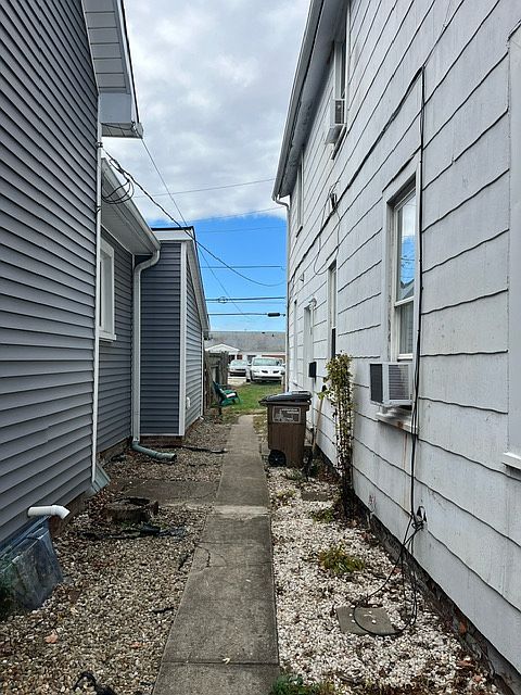 view from the front side yard into the backyard (entry door is on the right)