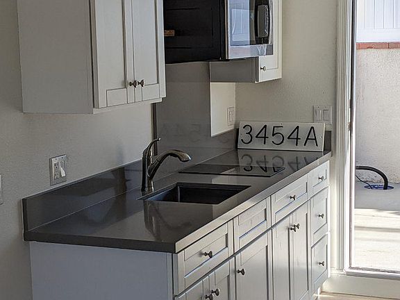 kitchen with sink, microwave, cooktop