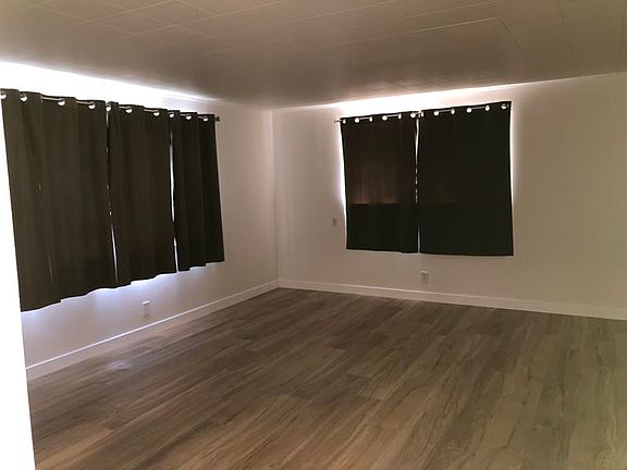 Living room curtains are included for privacy.