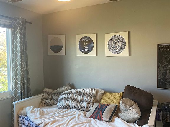 Middle sized bedroom is currently used as a guest room/office. Window faces the rear of the home. New ceiling fan added in March 2020