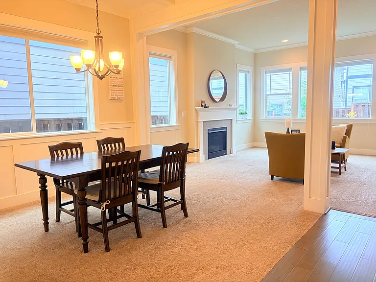 Formal dining room open to the great room with fireplace.