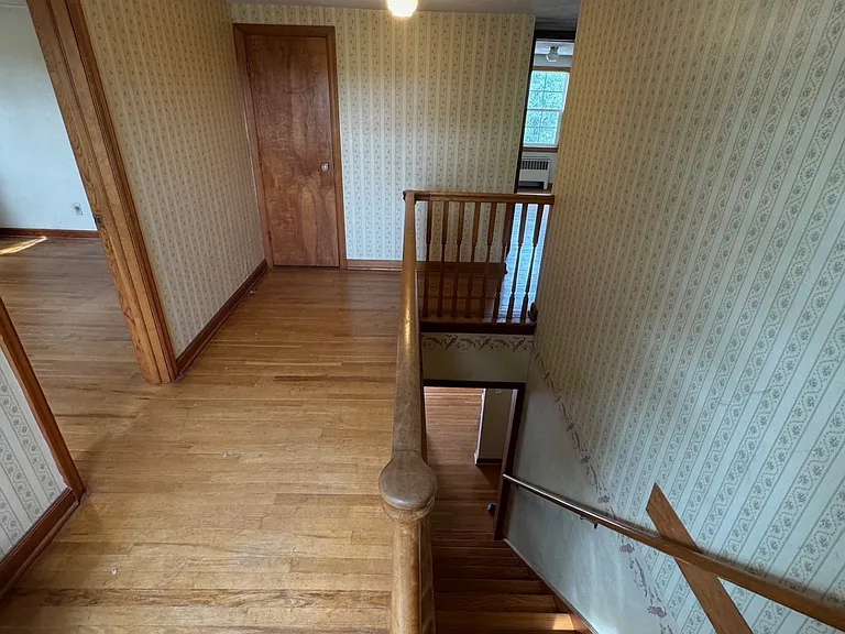 Top of the stairs looking at bedroom #1 to the left and bedroom #2 ahead to the right, and the 3rd bedroom and bathroom are around the corner.