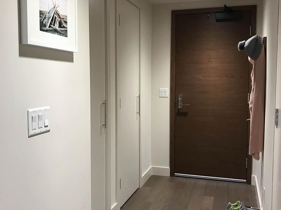 unit entryway (doors to coat closet and pantry on left)
