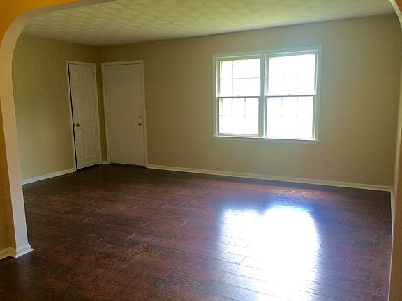 Living Room, with new hardwood floors & arched doorways