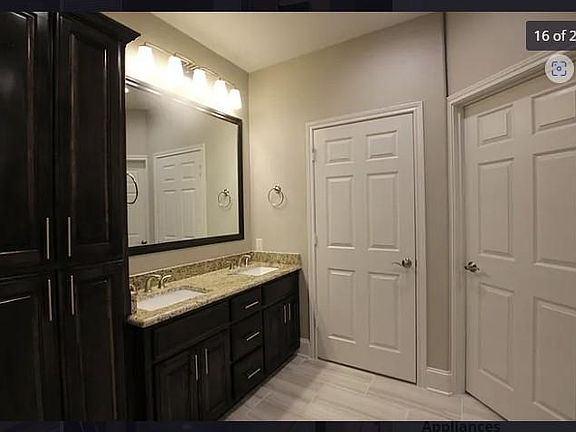 Master bath vanity with an abundance of cabinet space, granite with double sinks & brushed nickel fixtures.