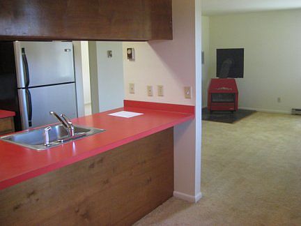 view from dining/kitchen area into living. (view is before new LVP flooring was installed)