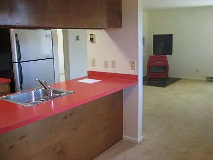 view from dining/kitchen area into living. (view is before new LVP flooring was installed)