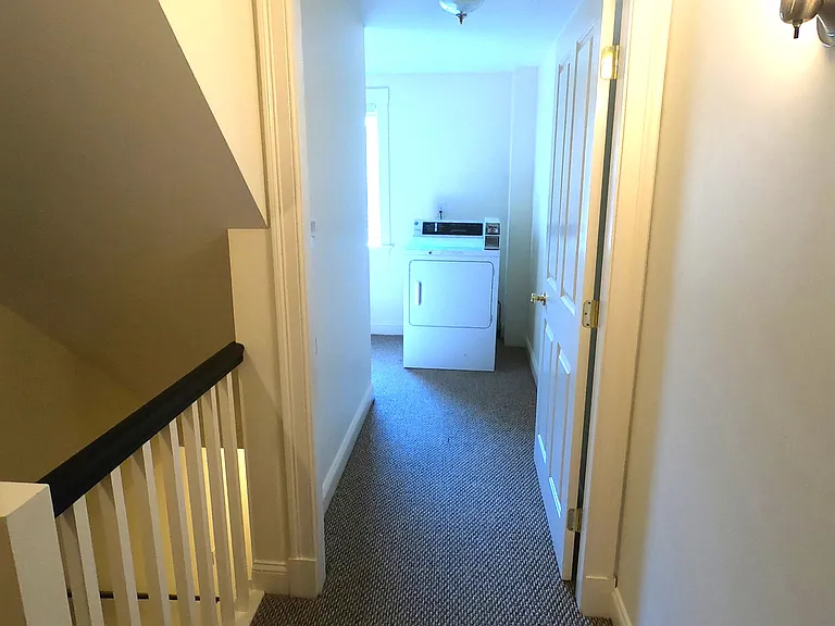Hallway to laundry area, shared by unit 2 and 3.