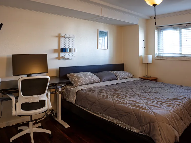 Bedroom one with king, mechanical standing desk to the left