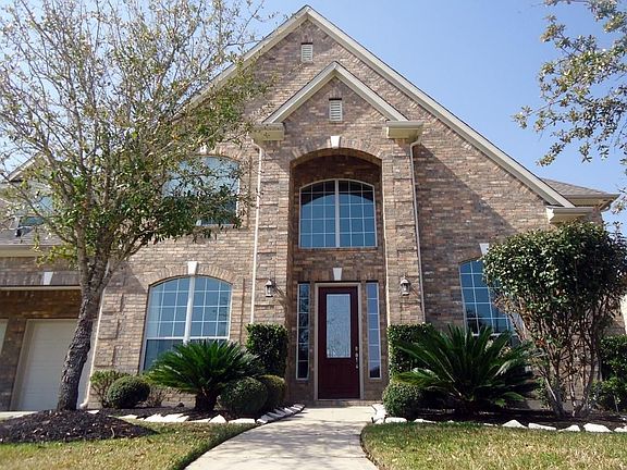 A two-story arched entryway welcomes you home.