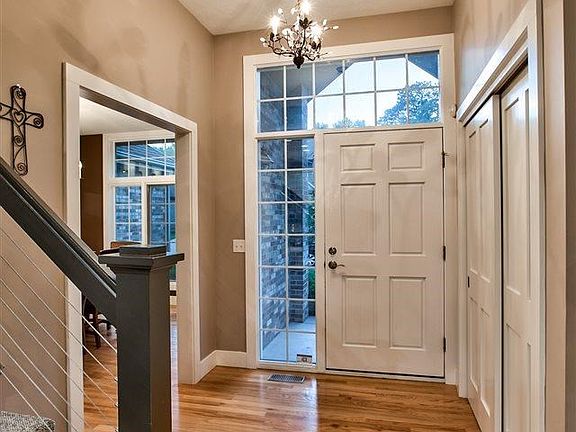 Entry way, traditional hard wood flooring leading into the kitchen area