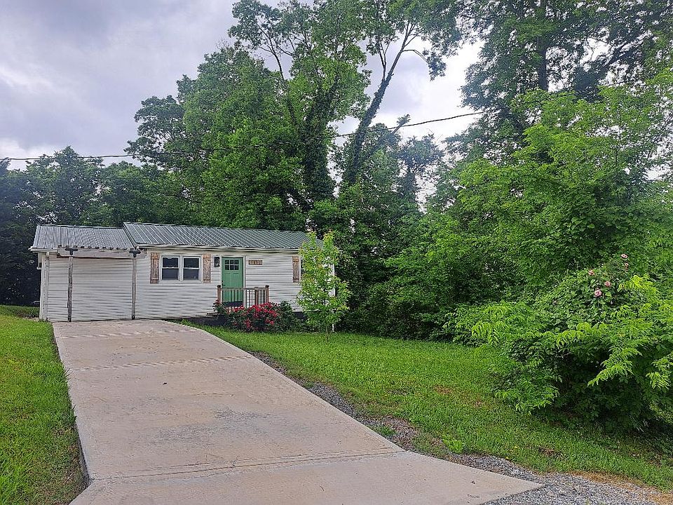 Large front and back yard with concrete driveway