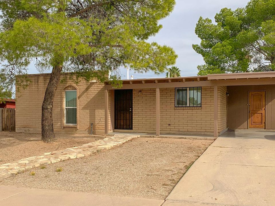 Front of the home. - 2-car porch, 1 covered spot. - Low maintenance front yard - 2 palm trees __and 1 pine tree __